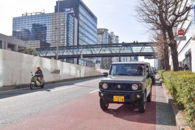 セルリアンタワーの歩道橋を背景にしたジムニー。歩道橋の上からは首都高渋谷線が見渡せる。駆け抜ける白いクルマたちはまるで脱兎の如し……
